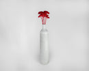 Tall white ceramic vase with a bulk bunch of naturally dried red yarrow flowers.