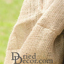 Natural tan jute cloth with coarse open weave, ideal for dried floral and bulk decor supplies.