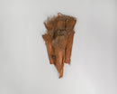 Bundle of dried natural palm nets in bulk, showcasing coarse fibrous texture and warm brown tones.