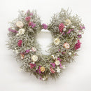 A 20-inch wide handmade decorative wreath made of dried flowers in a variety of colors.