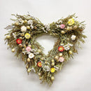 A 20-inch wide handmade decorative wreath made of dried flowers and greenery.