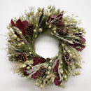 A dried holiday wreath with a variety of natural decorations including pine cones and dry flowers in shades of green, burgundy, and brown.