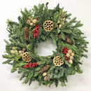 Natural dried holiday wreath with pinecones, red berries, and lotus pods, wholesale bulk design.