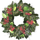 A round wreath decorated with preserved green leaves, twigs, and red canella berries.