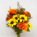 A bouquet of dried and silk flowers including poppies, sunflowers, and oak leaf foliage, primarily in shades of yellow, orange, and green.