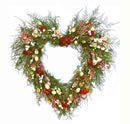 A heart-shaped wreath made of greenery with red and white flowers and berries.