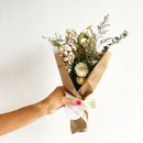 Small dried flower bouquet with white and yellow blooms wrapped in brown kraft paper with cream ribbon for natural wholesale .