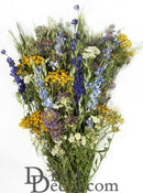 A dried mountain meadow flower bouquet with a variety of colors including yellow, purple, white, green, and blue.