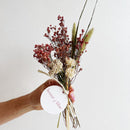 Handheld small dried flower bundle with pink and cream blooms and natural stems, wholesale bulk.