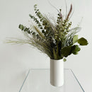 Natural dried green foliage arrangement in a white cylindrical vase, wholesale bulk bouquet.