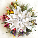 Large dried flower bundles in bright orange, yellow, and natural tones, bulk wholesale arrangement.