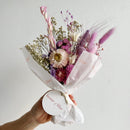 Bulk dried flower bundle with natural purple, lavender, and blue tones wrapped in white paper.