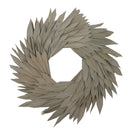 A 17 inch round wreath made of natural palm sun leaves on a coco fiber base, with a beige color tone.