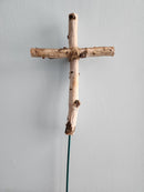 A white birch cross approximately 12 inches long and 6 inches wide mounted on a vertical pick, against a plain background.