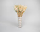 Bulk bundle of dried natural mixed grain wheat with long stems in striped white vase.