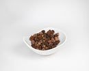 White bowl filled with small dried natural brown black spruce cones for bulk wholesale use.