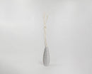 Dried natural mitsumata branches in off-white color arranged in a tall gray vase, wholesale bulk decorative accents.