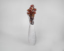 Bundle of dried natural rose hips in red and green tones arranged in a tall white ceramic vase.