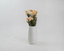 Bulk dried blush straw flowers with natural stems in a white vase.