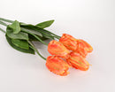 A bundle of artificial orange and yellow tulip stems with green leaves on a white background.