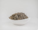 White bowl filled with dried natural Spanish moss in bulk on a plain background.
