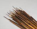Bulk dried pencil cattails in natural brown tones with slender stems, wholesale bunches.