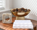 Natural dried Sequoia pine cones in a bulk gold pedestal bowl on wooden table.
