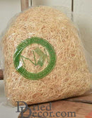 Bulk natural wood excelsior in clear plastic bag with green logo label, dried floral supply material.