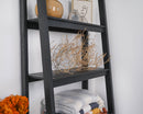 Large natural dried tumbleweed displayed on black wooden shelf for wholesale bulk decor.