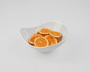 Natural dried orange slices displayed in a white bowl, ideal for wholesale bulk use.