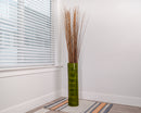 Eight bunches of natural light brown dried Asian willow branches in a tall green vase, wholesale bulk display.