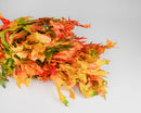 Bulk bundle of dried natural oak leaves in harvest tones with orange, yellow, and green hues.