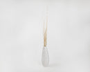 Dried natural birch branches painted gold in a tall white ceramic vase, wholesale bulk bundle display.