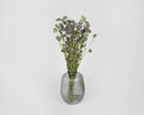 Bulk dried lemon mint flower bouquet with small purple blooms in clear ribbed glass vase.