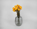 Dried natural yellow strawflowers arranged in a ribbed glass vase, wholesale bulk bouquet.