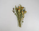 Bundle of dried natural wildflowers with yellow, purple, and orange blooms in bulk wholesale bunches.