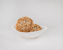 Two natural tan curly willow decorative balls, dried and woven, displayed in a white bowl, wholesale bulk style.