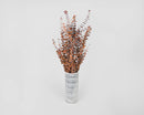 Bulk dried eucalyptus stems with autumn tones arranged in a white striped vase, natural wholesale bunches.