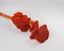 Bulk dried yarrow flower bunches in vibrant natural orange color with long stems.