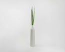 Tall dried green Oceana palm leaves arranged in a white textured vase, natural wholesale bulk decor.
