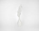 White dried spear palm fronds arranged in a tall, narrow white vase against a plain background.