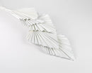 White dried spear palm fronds bundled in bulk for natural beach decor.
