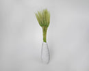 Green dyed wheat stalks arranged in a white vase, dried natural wheat bundles in bulk.