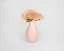Dried natural sponge mushrooms arranged in a pink ceramic vase for wholesale bulk display.