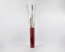 Natural dried white birch poles with peeling bark arranged in a tall red vase, wholesale bulk display.