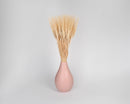 Natural dried wheat bundles arranged in a pink vase, wholesale bulk decor option.