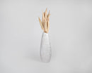 Dried natural okra pods bunch in tall white ceramic vase, bulk wholesale decor.