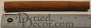 Single natural dried cinnamon stick measuring approximately 6 inches on a ruler background.