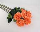 A spray of peach-colored artificial roses with green leaves, showcasing the realistic touch and detail of the product.