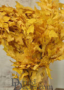 Bulk natural dried yellow leaves arranged in a dense bouquet for wholesale use.